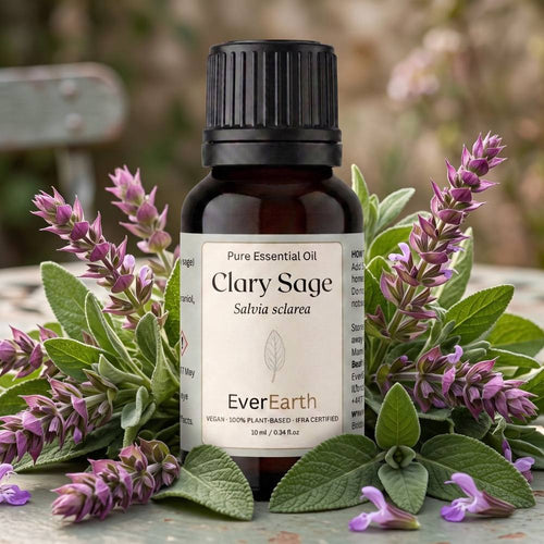 EverEarth Clary Sage essential oil bottle surrounded by fresh purple clary sage flowers and sage leaves