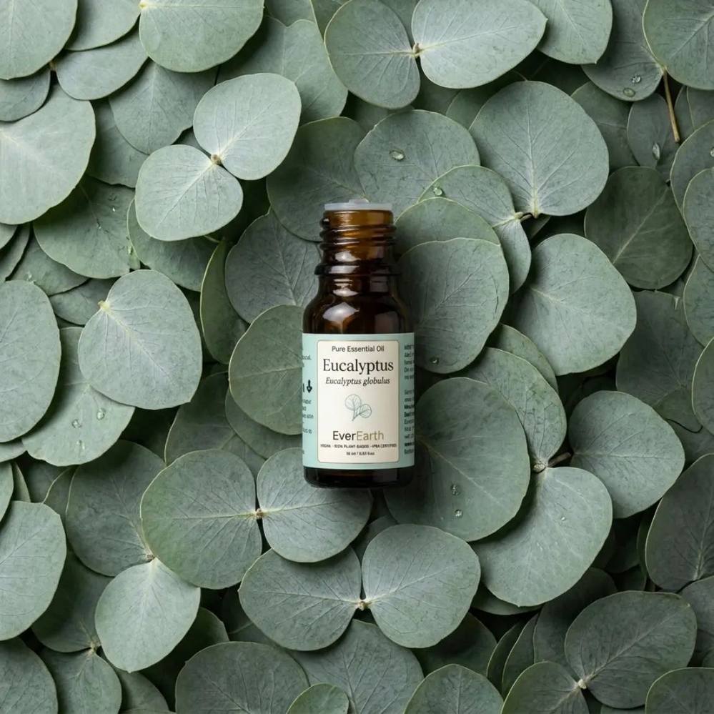 EverEarth Eucalyptus essential oil bottle resting on a bed of fresh eucalyptus leaves