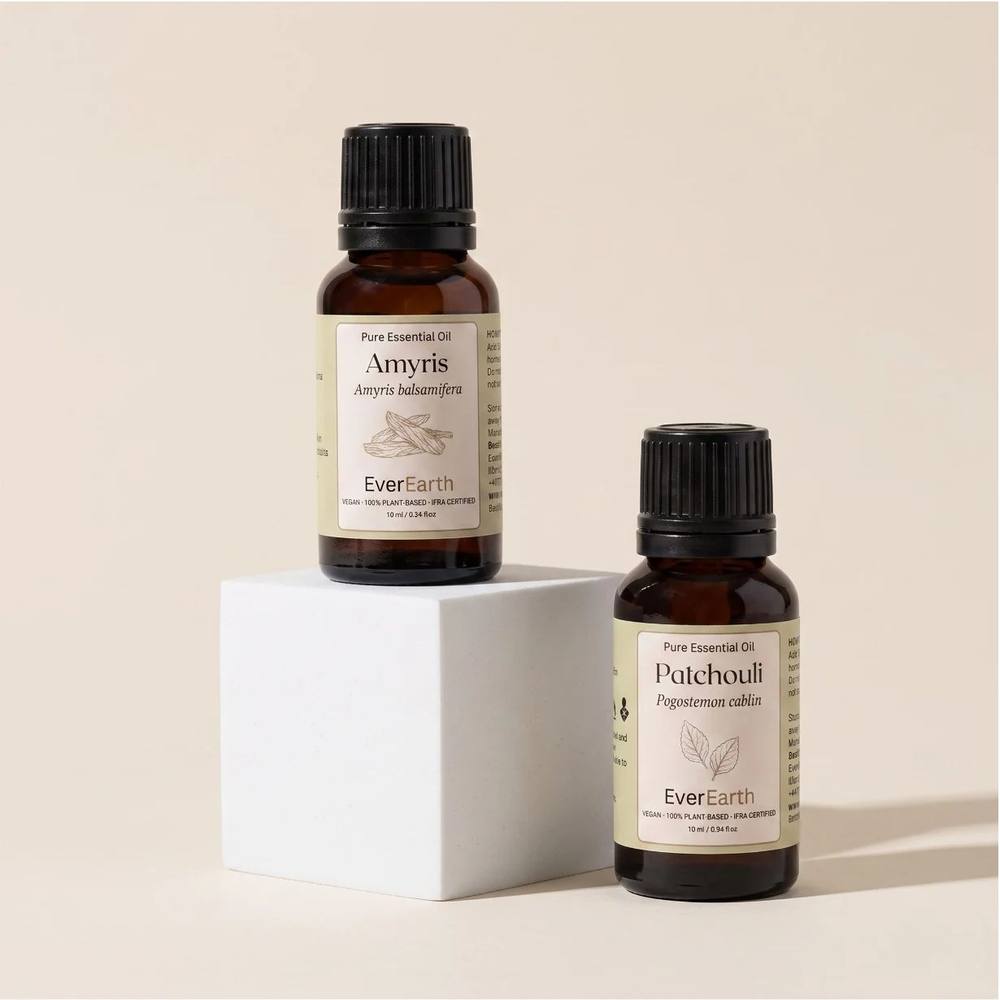 EverEarth Warm Duo, Amyris and Patchouli on a white pedestal, soft studio light