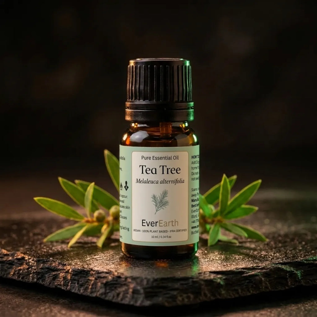 EverEarth Tea Tree essential oil bottle on dark slate with fresh tea tree sprigs