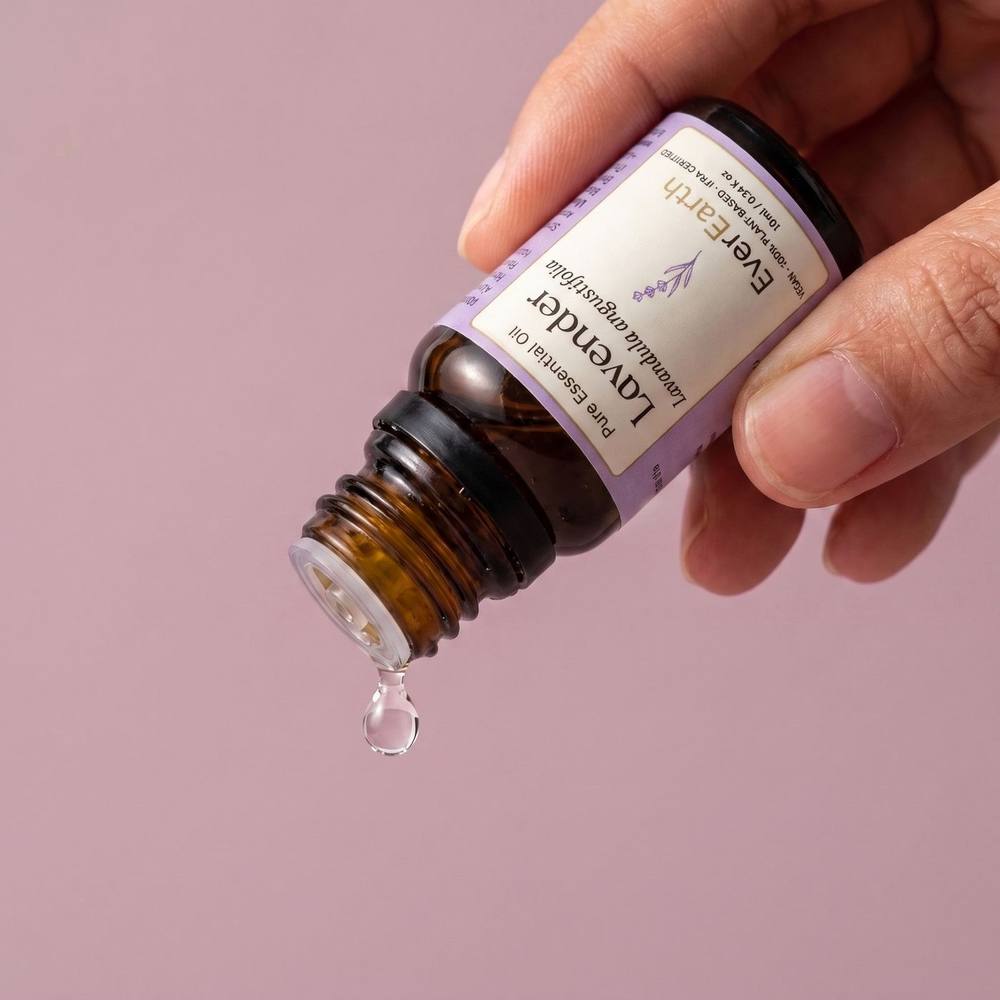 Hand tilting EverEarth Lavender essential oil bottle to release a single drop